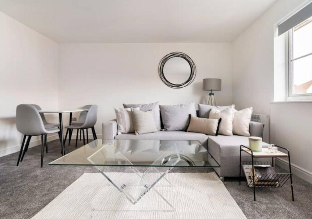 a living room with a couch and a table at Peniel Properties - Welwyn Garden City in Welwyn Garden City