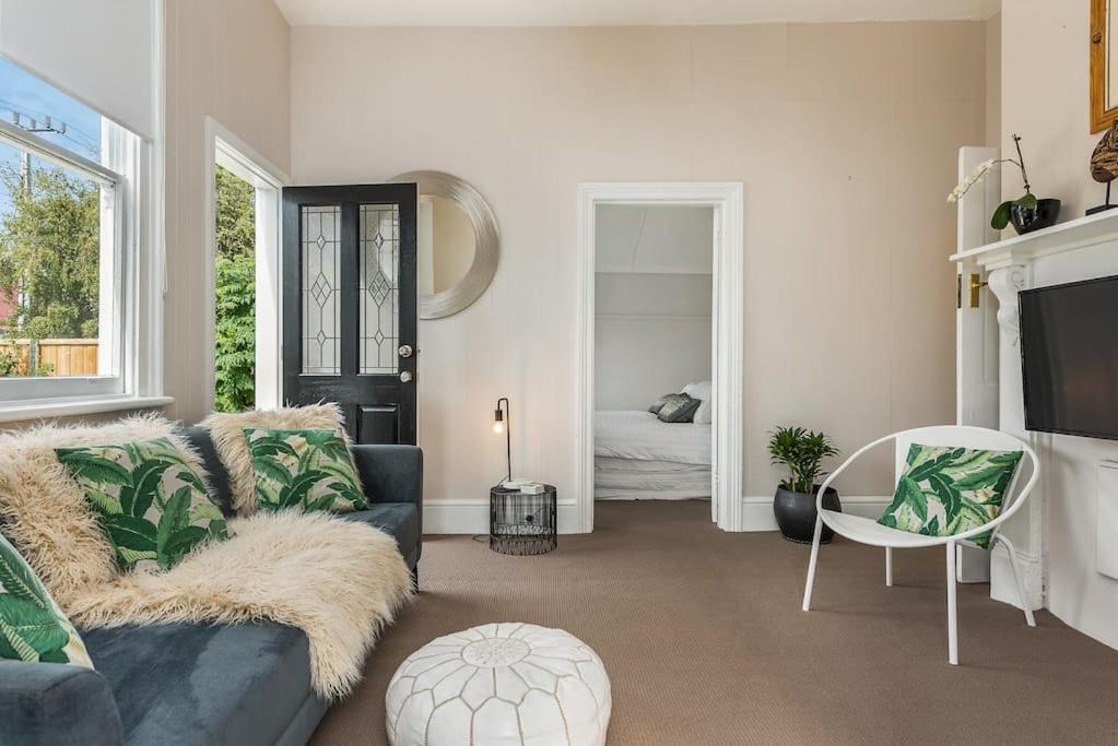 a living room with a couch and a table at North Hobart cottage in Hobart