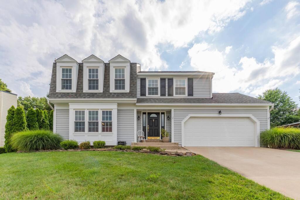 a white house with a garage at Stunning Vacation Home /Private Theatre/Fire pit in Fairfax
