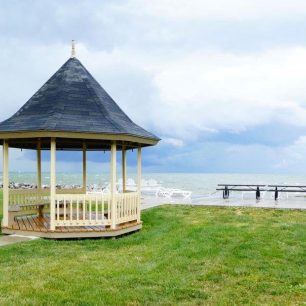 a gazebo with a cross on it next to the beach at Clinton Inn & Suites in Port Clinton