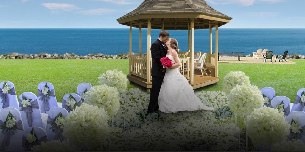 a bride and groom kissing in a gazebo at Clinton Inn & Suites in Port Clinton