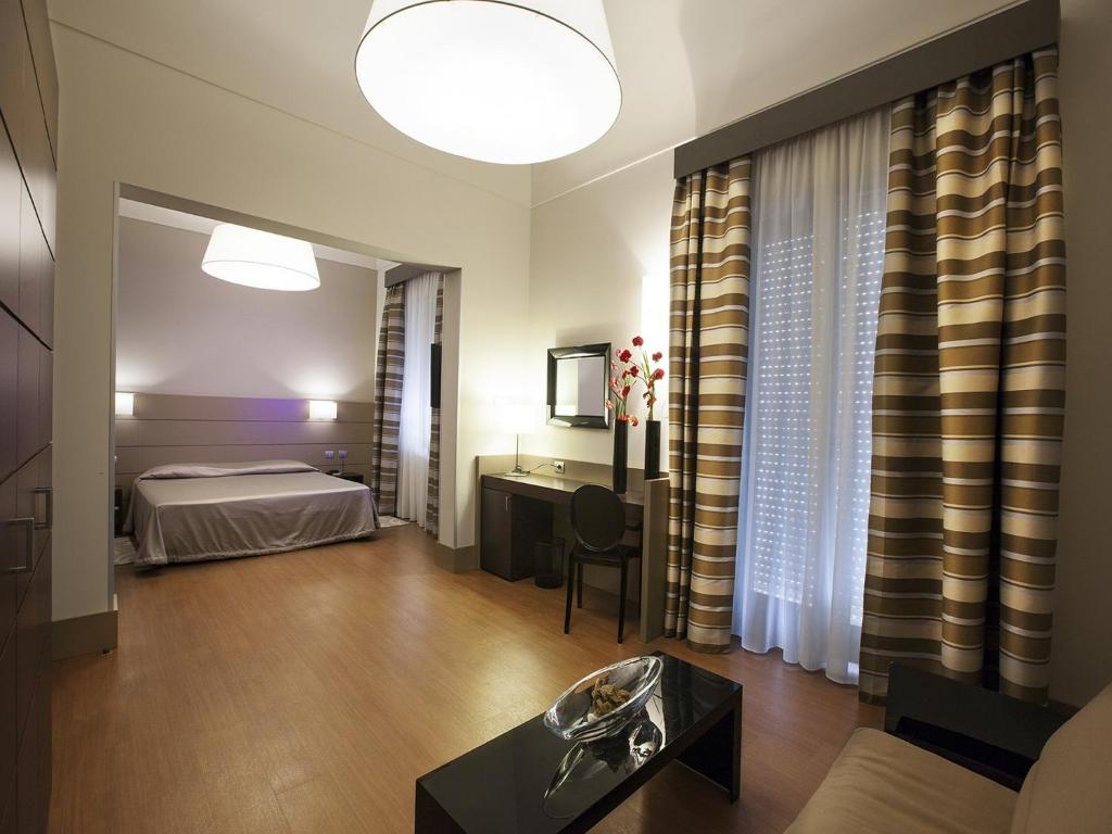 Postel nebo postele na pokoji v ubytování Hotel Vittoria