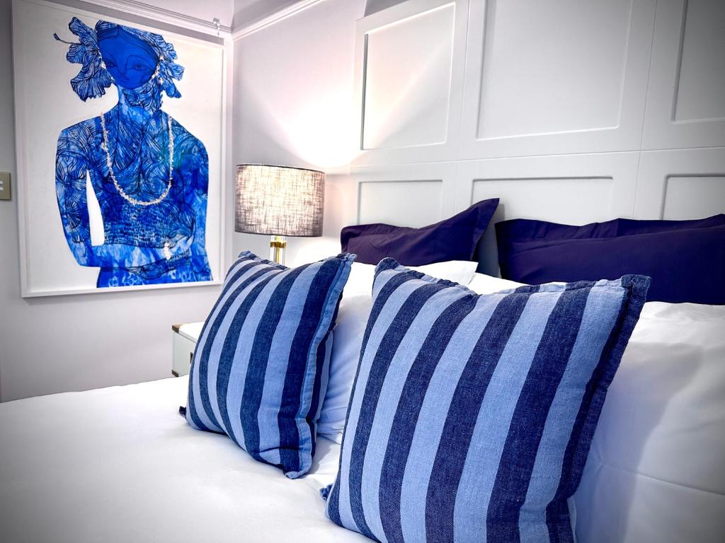 a bedroom with a bed with blue and white pillows at Ciao Bella in Brisbane