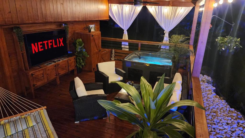 a living room with a hot tub and a tv at Palm's Luxury Suite with Private Jacuzzi in Aguada
