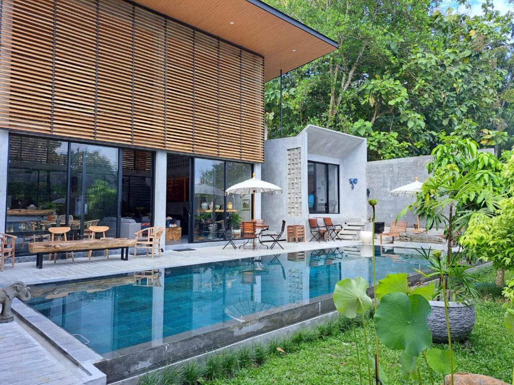 a house with a swimming pool in the yard at DJipangan Home in Bantul