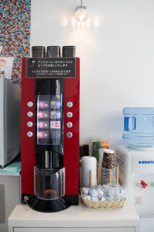 a red coffee maker sitting on top of a counter at Hotel Santa Barbara Miyakojima Resort in Miyako-jima