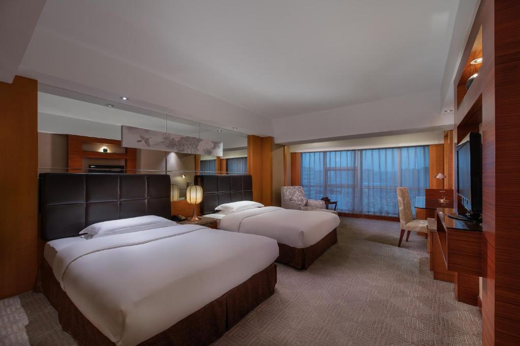 Postel nebo postele na pokoji v ubytování Empark Grand Hotel Xi'an
