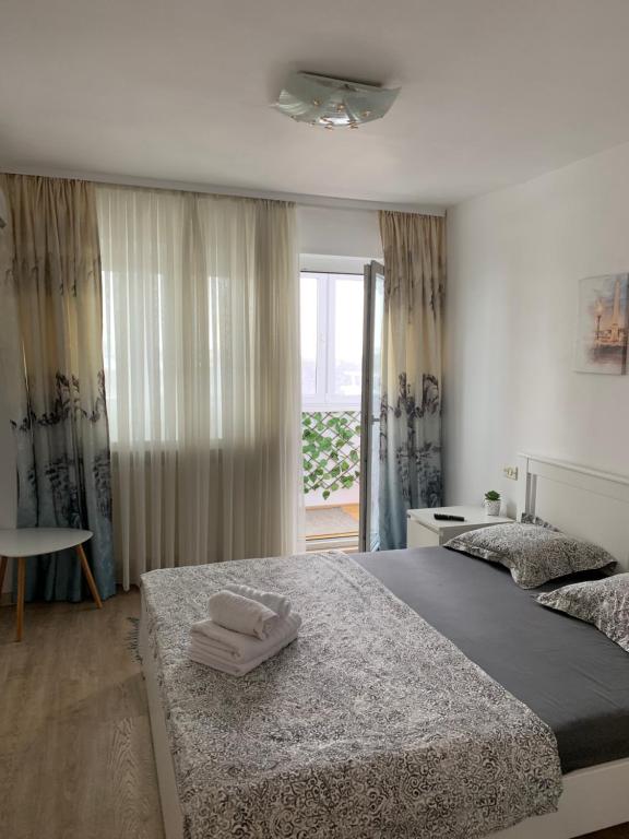 a bedroom with two beds with towels on them at Apartament Viorela in Alba Iulia