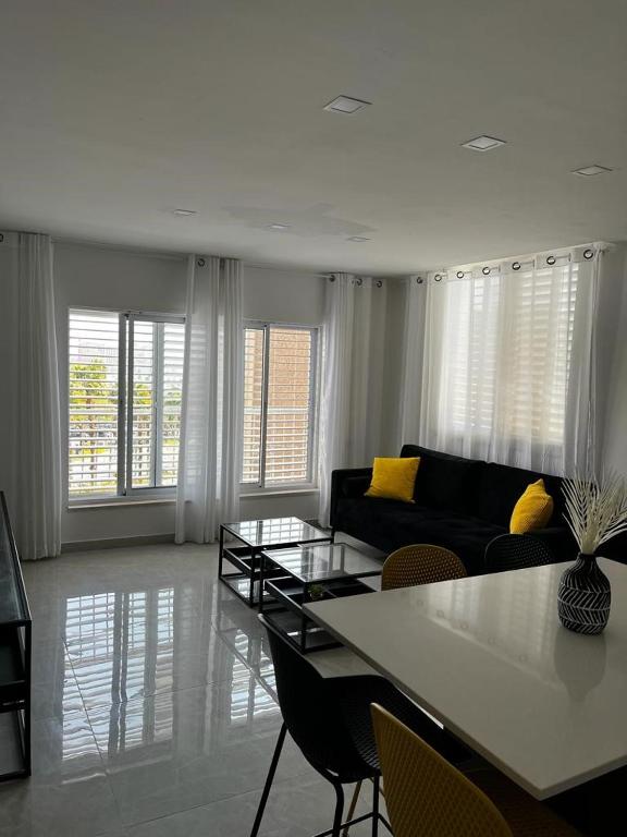 a living room with a couch and a table and chairs at מישל נופש ,צופית תחתית 6003 in Eilat