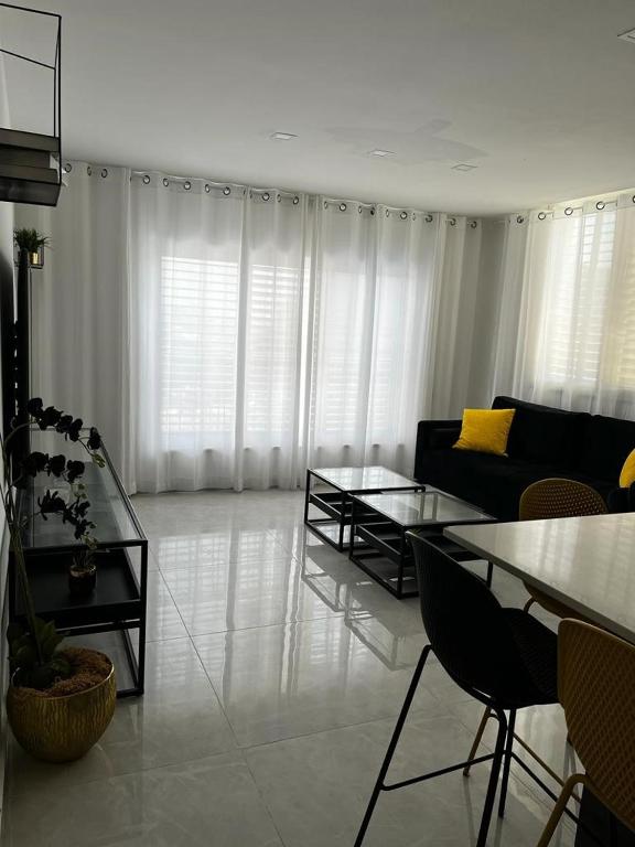 a living room with a couch and a table at מישל נופש ,צופית תחתית 6003 in Eilat