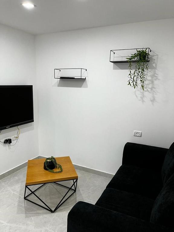 a living room with a couch and a table at מישל נופש ,צופית תחתית 6003 in Eilat