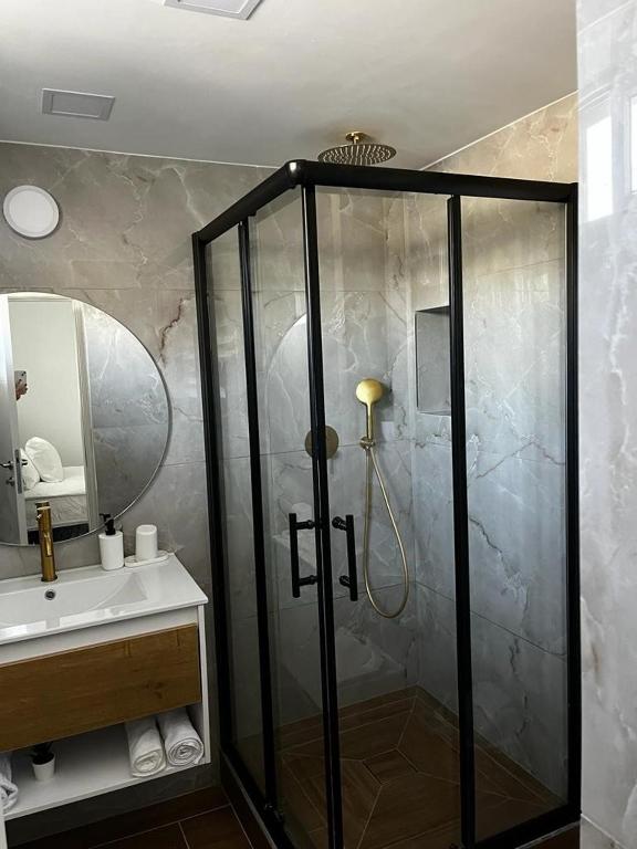 a bathroom with a shower and a sink at מישל נופש ,צופית תחתית 6003 in Eilat