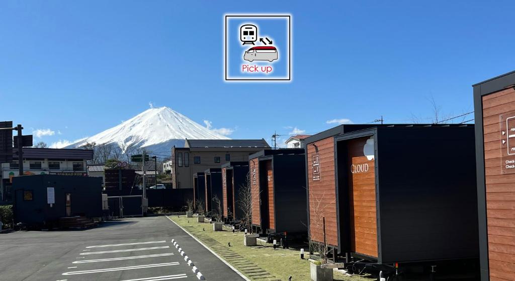 a mountain in the background with a row of shipping containers at Mt. Fuji Glamping MOONLIGHT VILLA Kawaguchik in Fujikawaguchiko