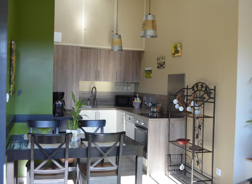 a kitchen with a table and some chairs in it at Gite Du Petit Coteau in Vouvray