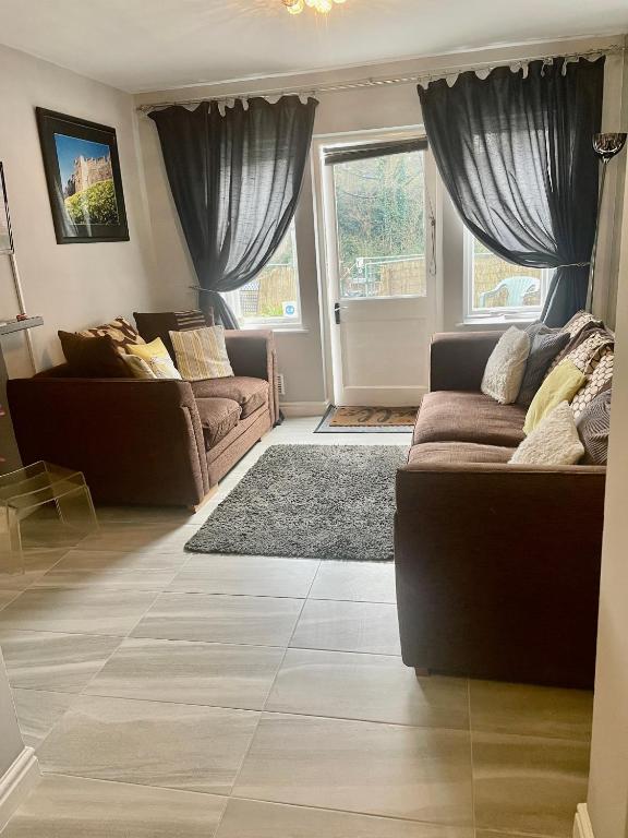 a living room with two couches and a rug at Gillygate Holiday Apartment in York