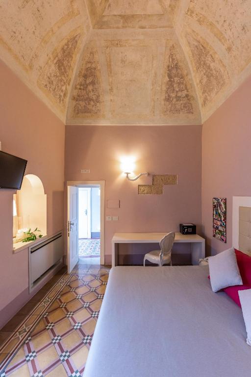 Postel nebo postele na pokoji v ubytování Palazzo Arco Cadura Hotel & Spa