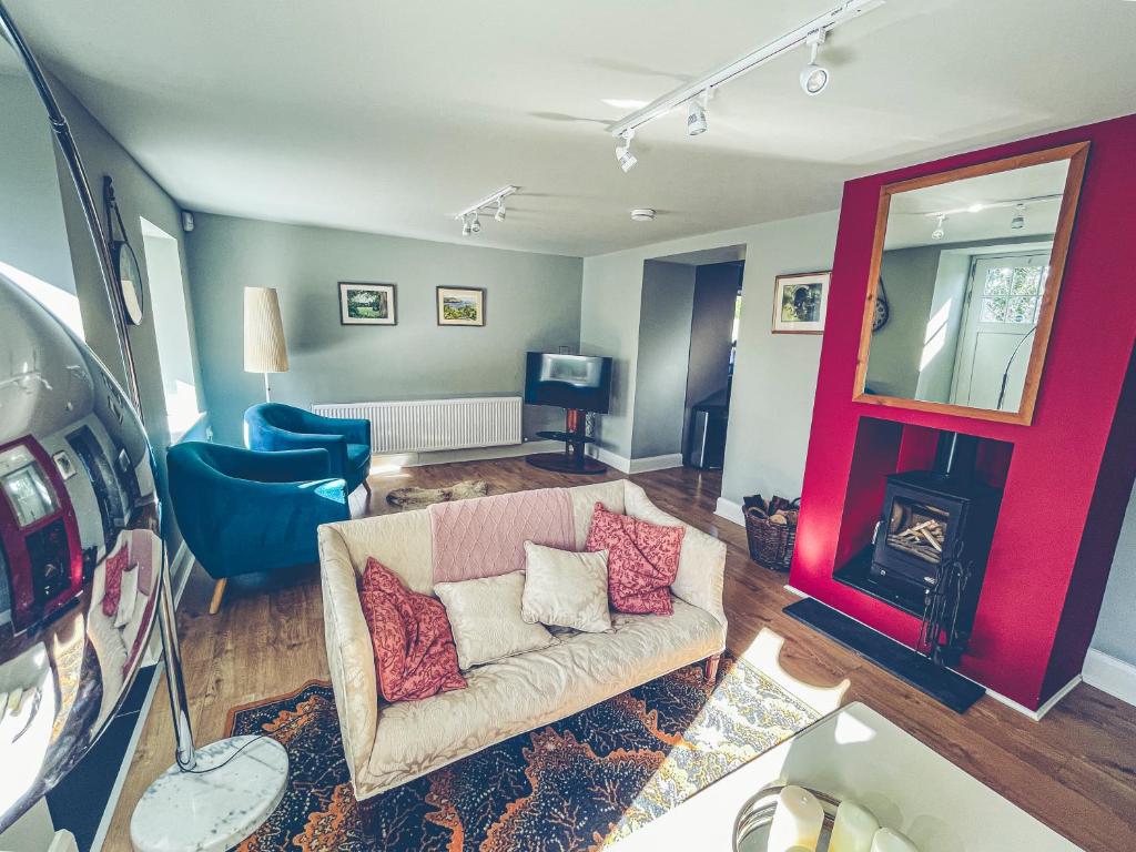 a living room with a couch and a fireplace at Maytown Cottage in Rosslare