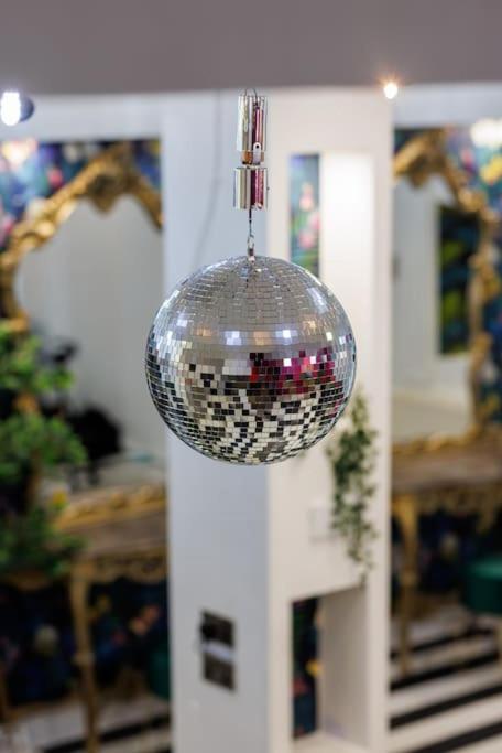 a disco ball hanging from the ceiling in a room at Spacious Liverpool Party Pad with 4 Bedrooms! in Liverpool