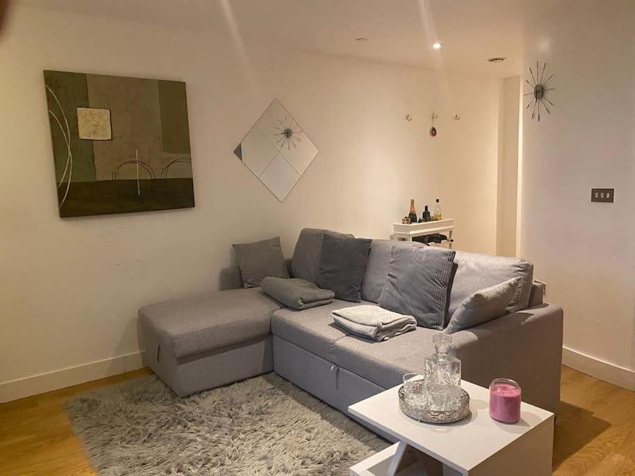 a living room with a couch and a table at Beautiful 1 bedroom flat in Leeds