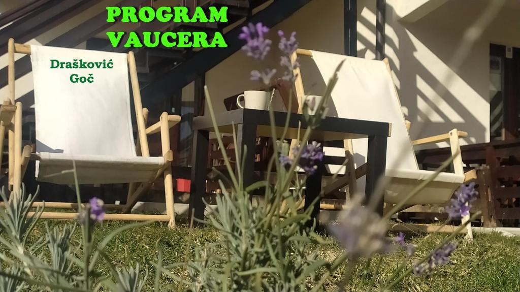 two chairs sitting on a porch with purple flowers at Apartmani Draškovic - Goč in Biserske Kuće