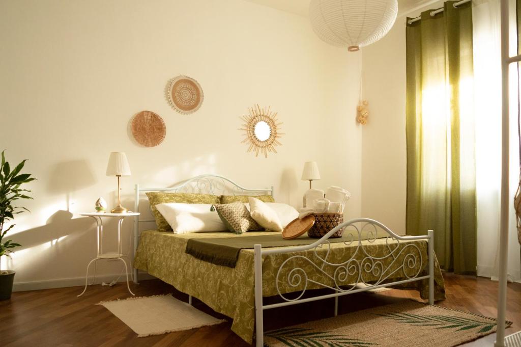 a bedroom with a bed and a mirror on the wall at PURA B&b in Noicattaro