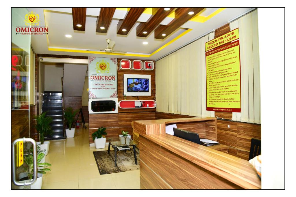 a lobby of a restaurant with a counter and avertisement at Hotel Omicron 1 BHK Studio room in Bangalore