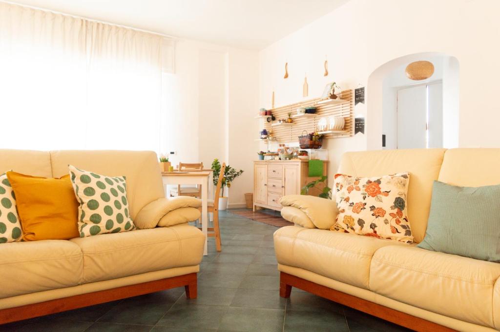 a living room with two chairs and a couch at PURA B&b in Noicattaro