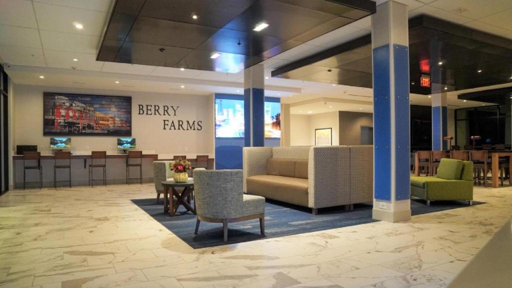 a lobby with a couch and chairs and a table at Holiday Inn Express & Suites Franklin - Berry Farms, an IHG Hotel in Franklin