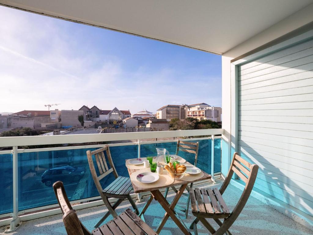 a table and chairs on a balcony with a view at Studio Le Grand Large by Interhome in Lacanau-Océan