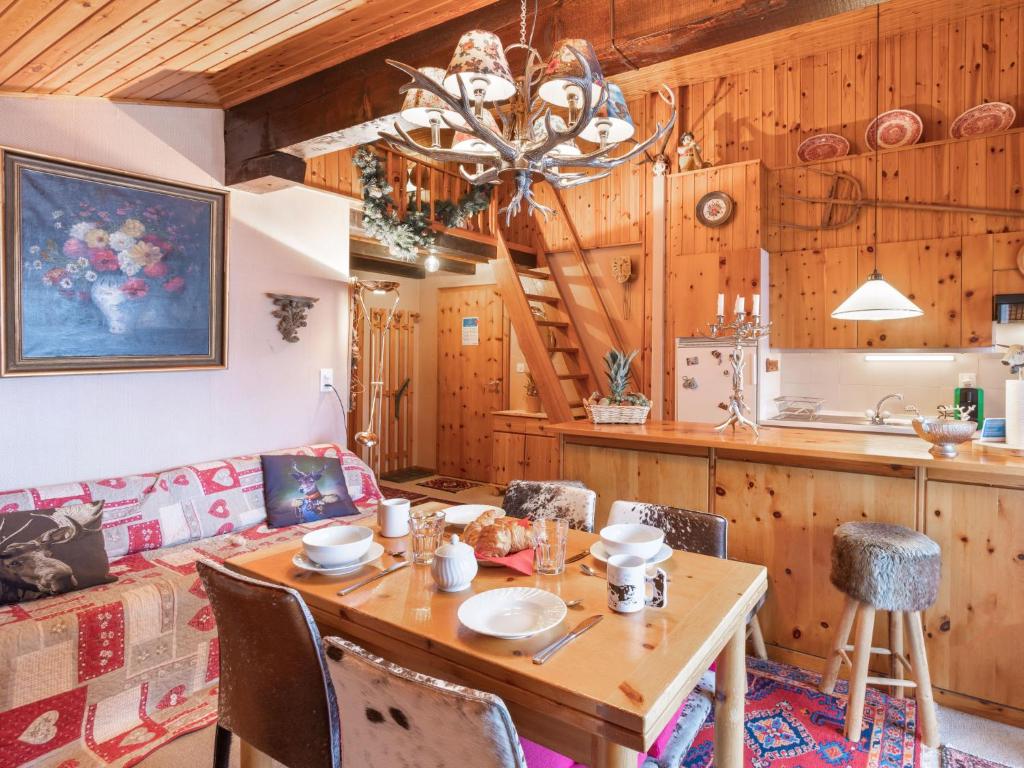 a living room with a table and a couch at Apartment Chaedoz 65 by Interhome in Nendaz