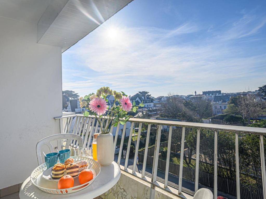 a table with a plate of oranges on a balcony at Apartment Kérabus-1 by Interhome in Quiberon