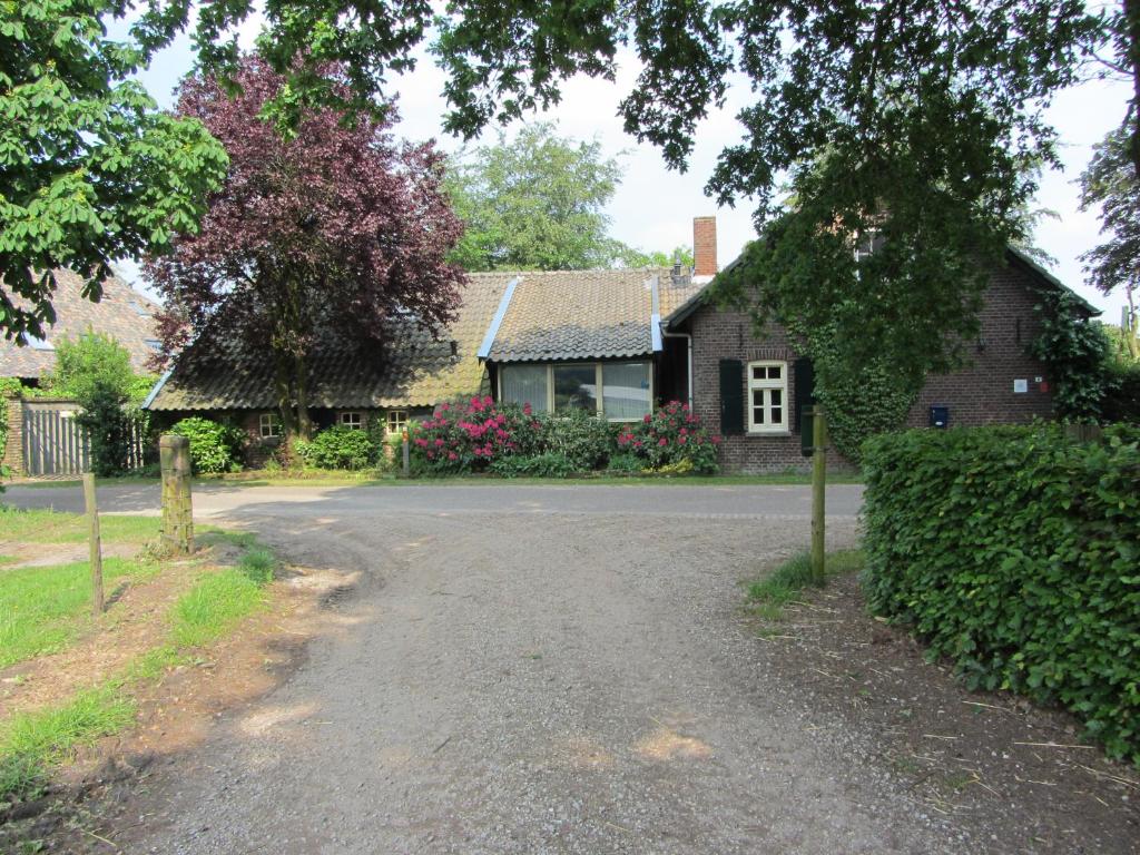 a house with a gravel road in front of it at Bergerhof de Stal in Sevenum