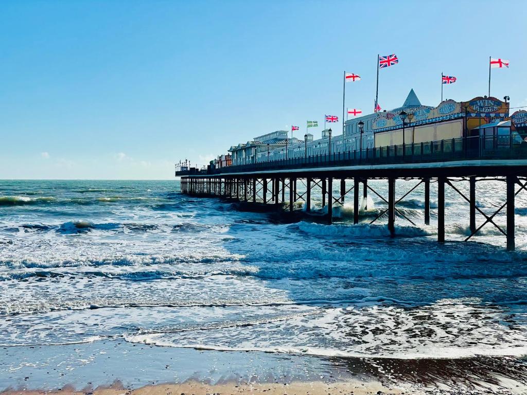 a pier on the beach next to the ocean at Seaside Homestay - Ensuite twin room with Kitchenette in Paignton