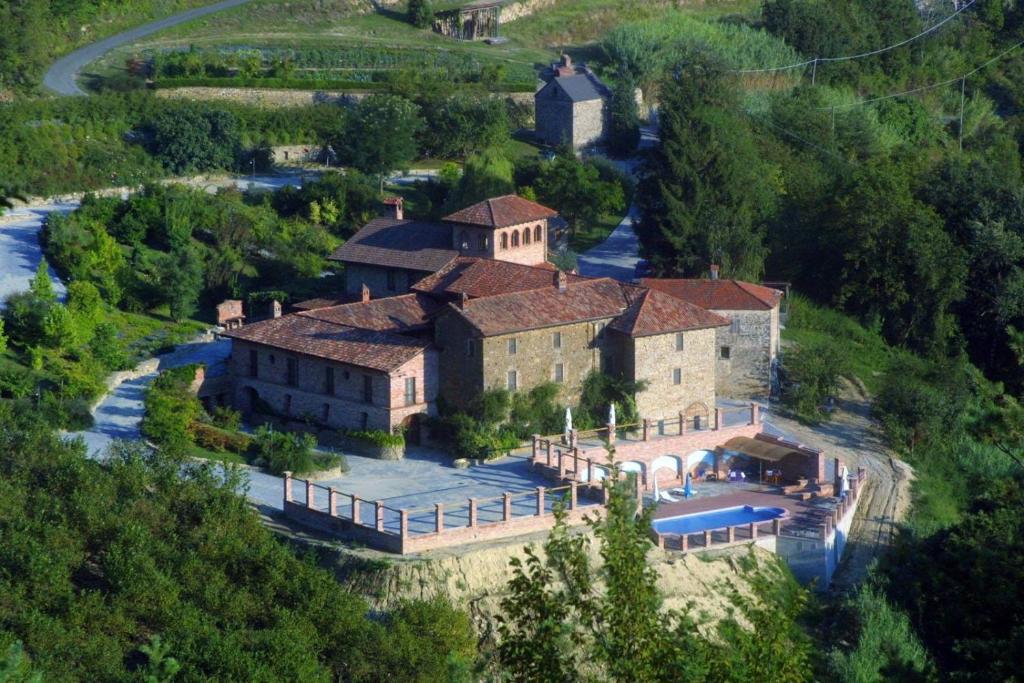 an aerial view of a large house with a swimming pool at Castel Martino in Cortemilia