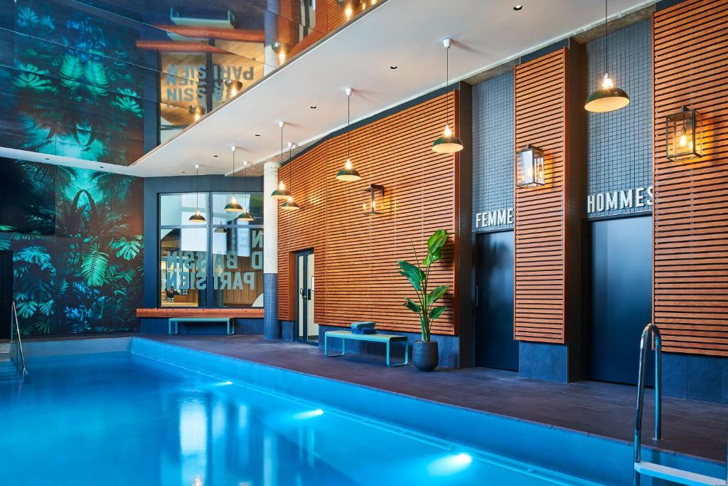 a swimming pool in a building with a swimming pool at Novotel Paris Gare De Lyon in Paris