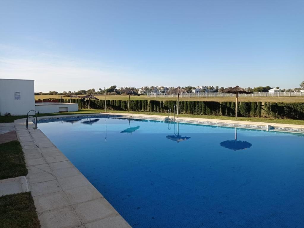 a large swimming pool with blue water at Costa Ballena Torresalada 1 in Costa Ballena