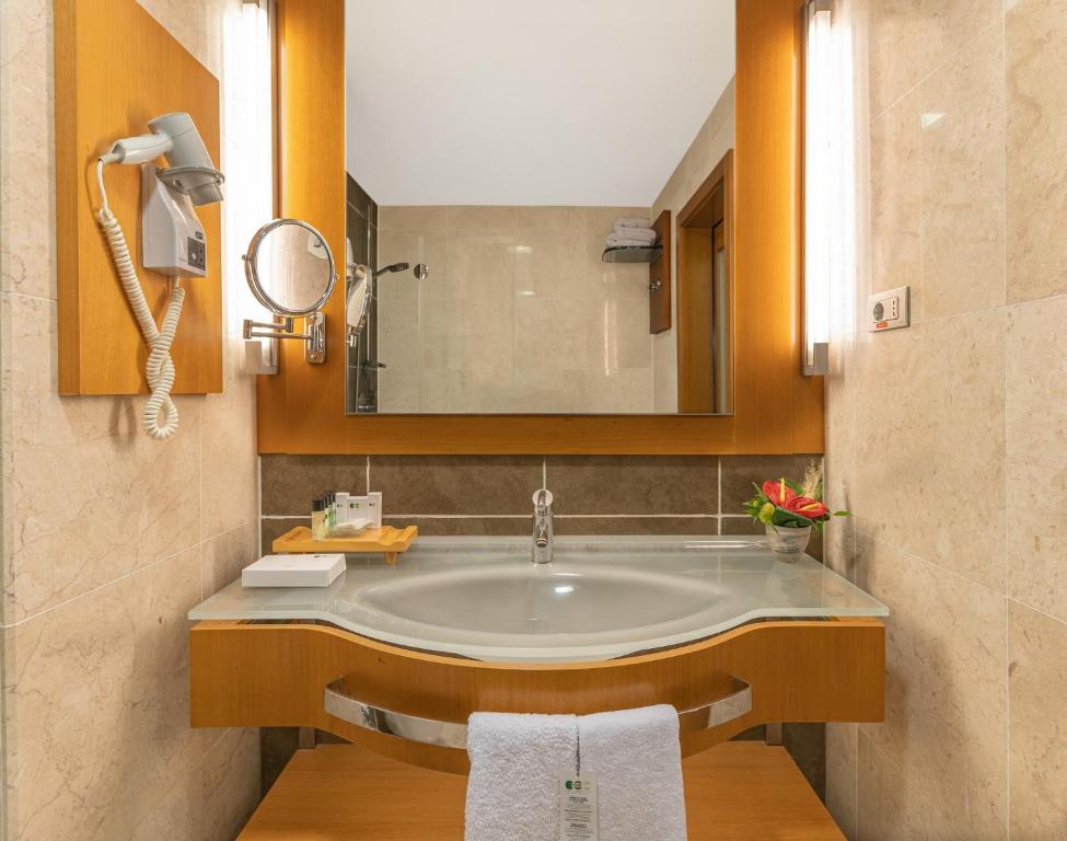 a bathroom with a sink and a mirror at Point Hotel Taksim in Istanbul