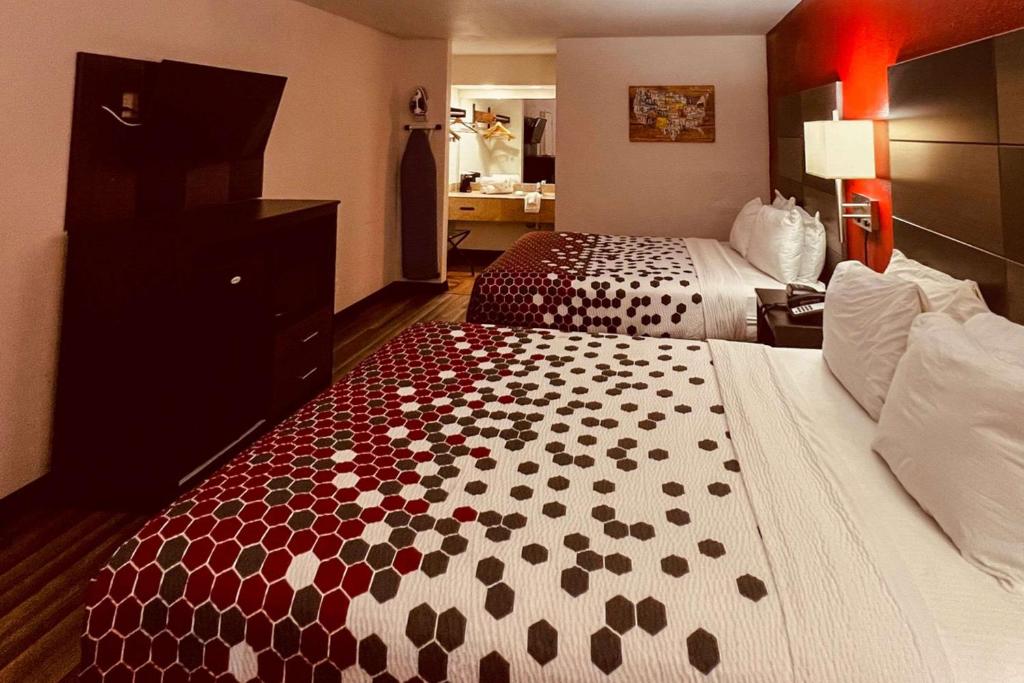 a hotel room with two beds with red and white at Econo Lodge Inn & Suites Downtown San Antonio Riverwalk Area in San Antonio
