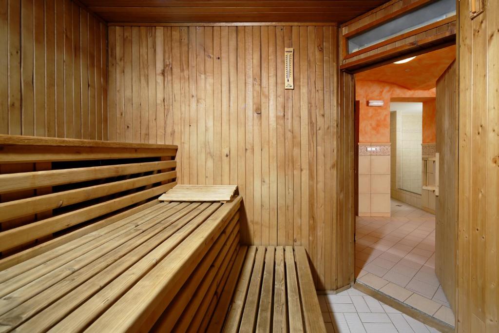 a sauna with a wooden bench in a room at OREA Spa Hotel Bohemia Mariánské Lázně in Mariánské Lázně