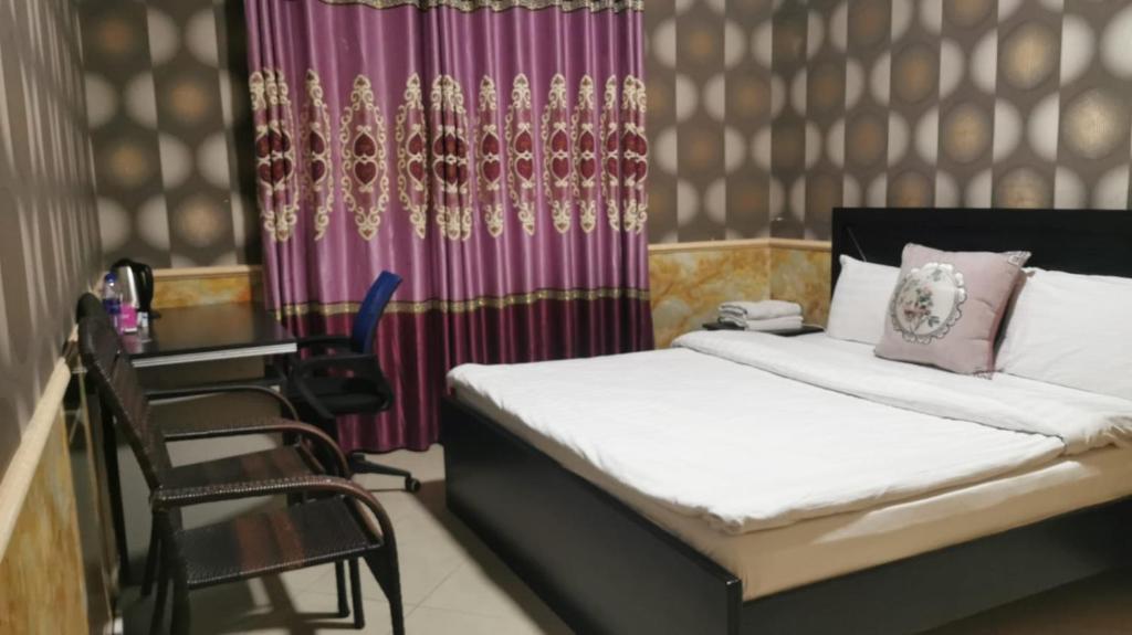 Postel nebo postele na pokoji v ubytování Jin Jie Residence
