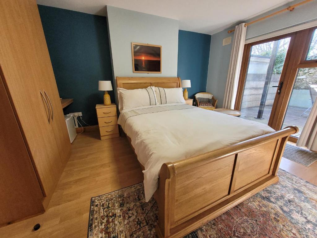 a bedroom with a large bed and a large window at Aonach in Dingle