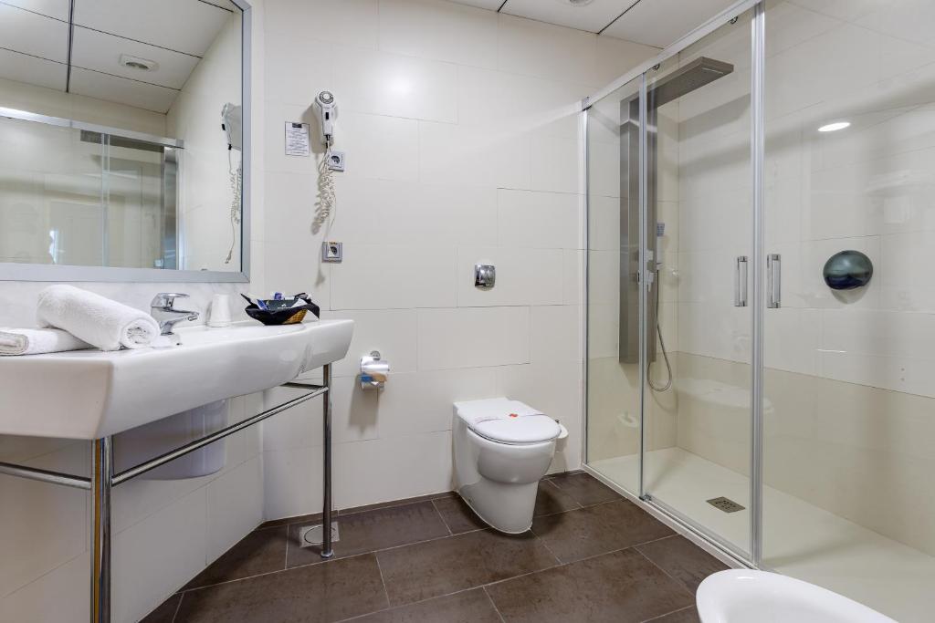 a bathroom with a shower and a sink and a toilet at Daniya Alicante in Alicante