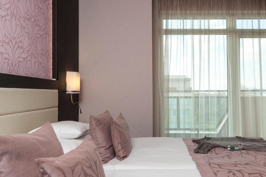 Postel nebo postele na pokoji v ubytování Hotel Wellamarin