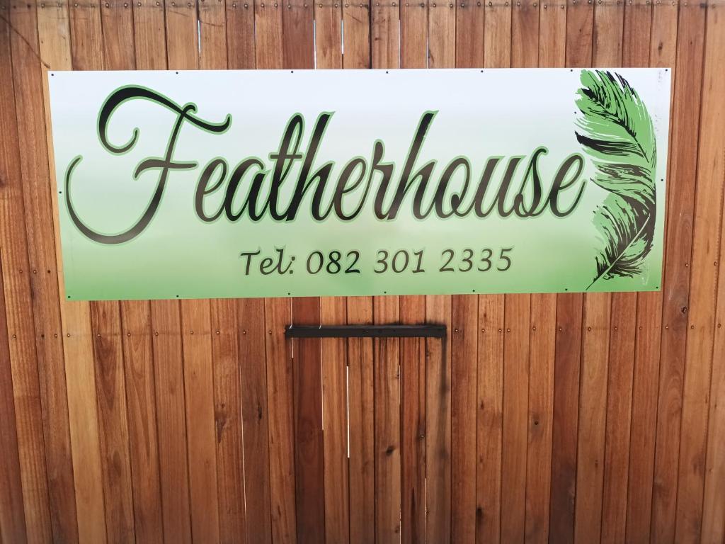 a sign on a wooden wall with aemedperatureperature sign at Featherhouse in Colesberg