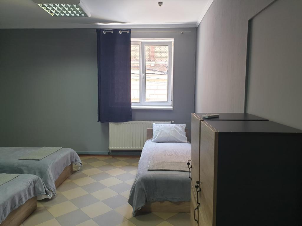 Postel nebo postele na pokoji v ubytování Мандри Хостел
