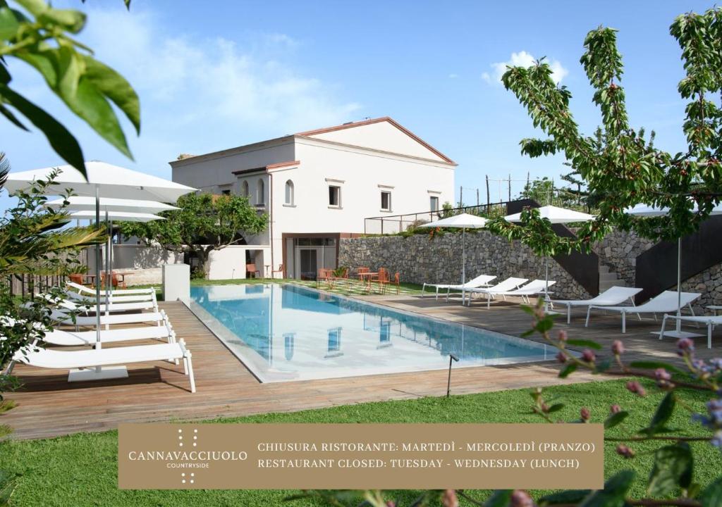 a villa with a swimming pool and a building at Laqua Countryside in Vico Equense
