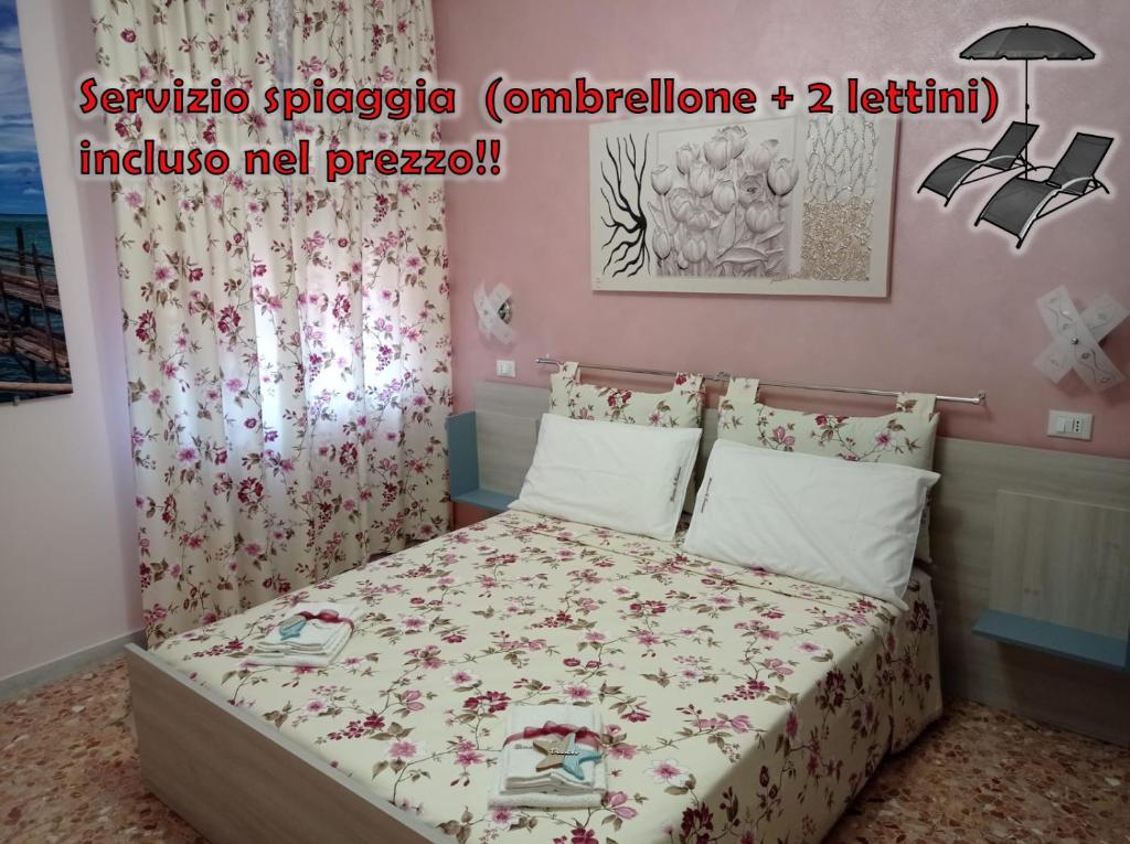 - une chambre dotée d'un lit avec un couvre-lit floral dans l'établissement Dimora il Trabucco, à Termoli