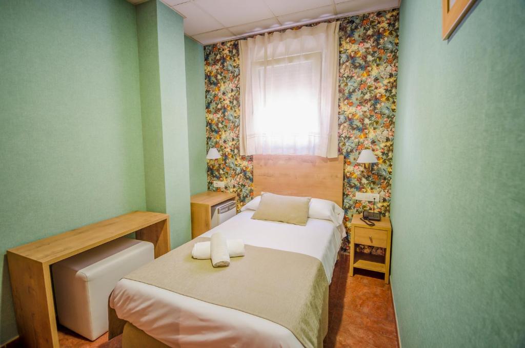 Postel nebo postele na pokoji v ubytování Hotel Solymar