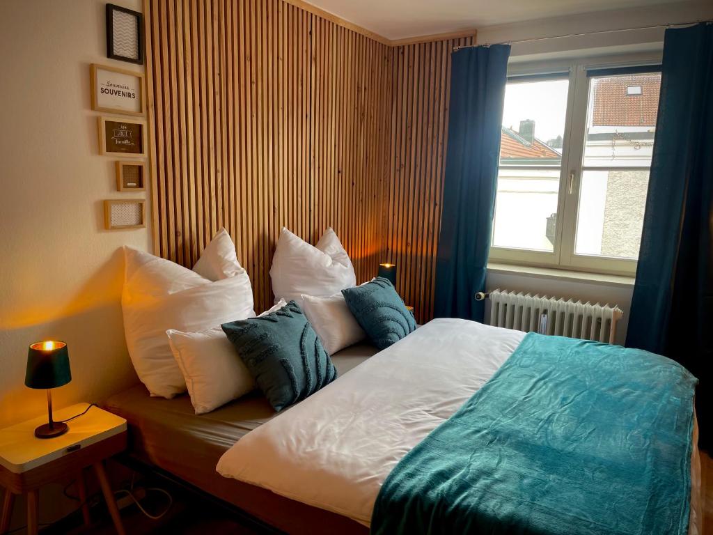 a bedroom with a bed with pillows and a window at Apartment three Rivers2 in Passau