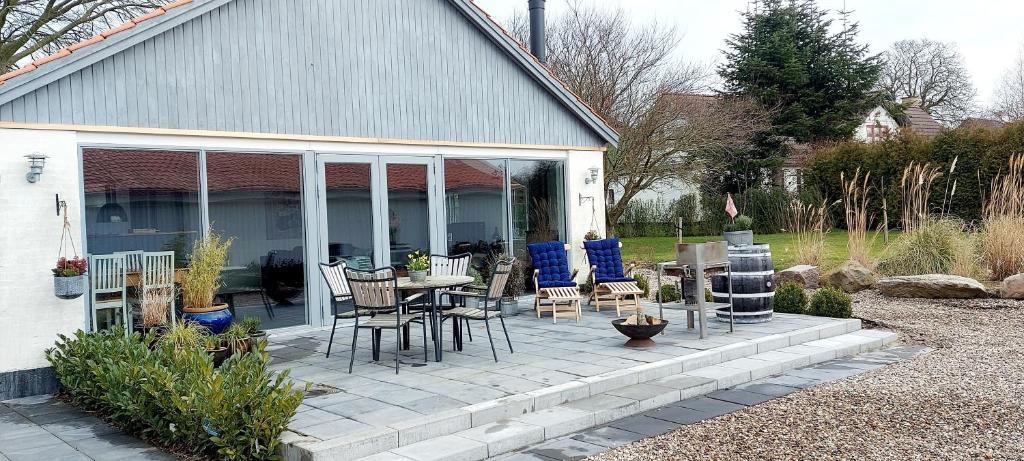 un patio con sedie e tavolo di fronte a una casa di Skovby 2 a Skovby